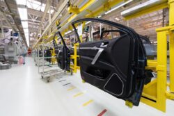 Car door in production with thermoplastic components on a production line